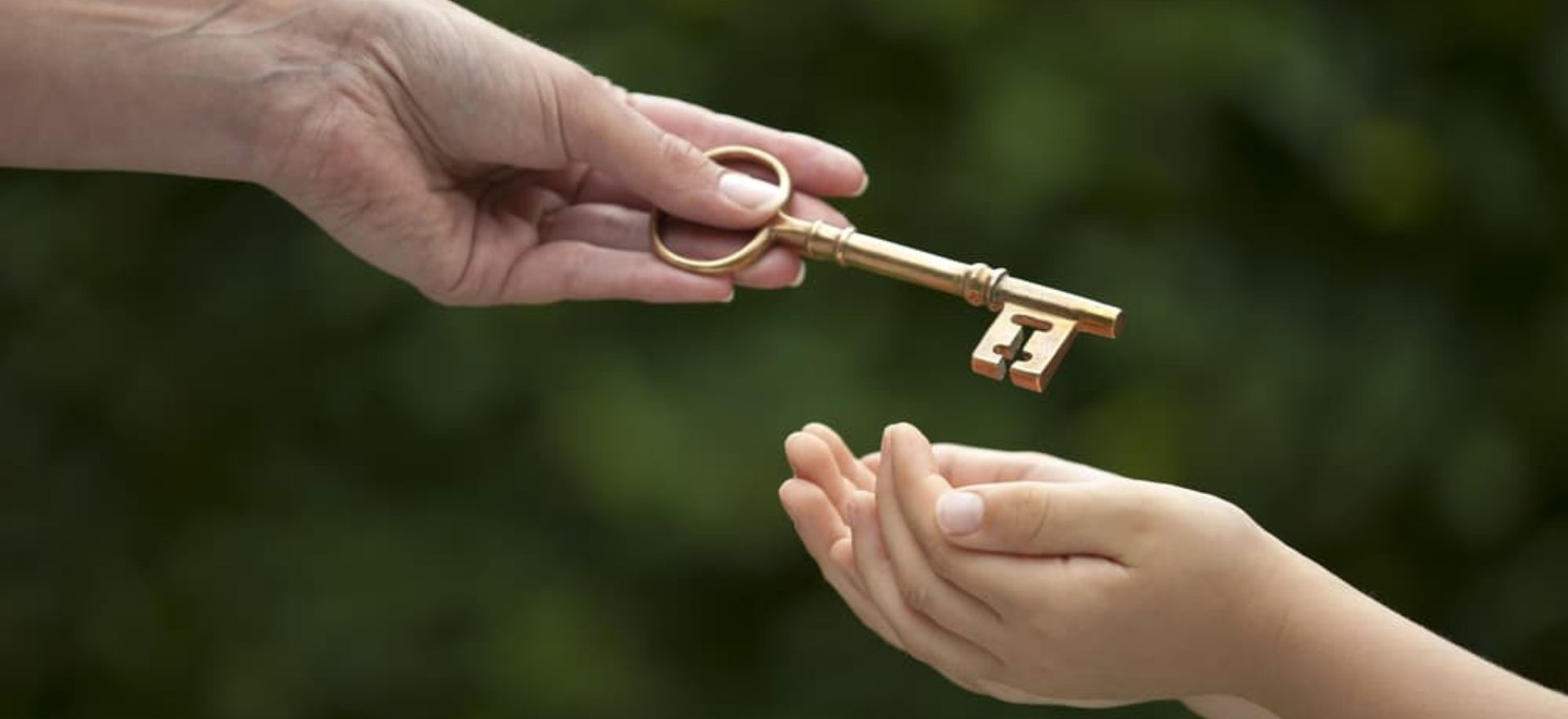 hand of a mother handling key to the daughter